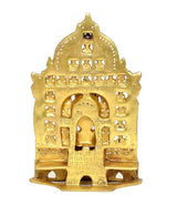 Brass Mahavir Swami statue back view with arched frame and decorative cutouts