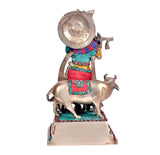 Brass Krishna with cow statue, front view, turquoise jewelry and red striped outfit