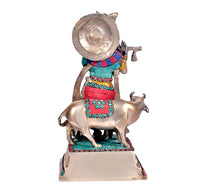 Brass Krishna with cow statue, front view, turquoise jewelry and red striped outfit