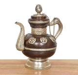 Ornate brass teapot showpiece with decorative side handles, chain, and domed lid finial