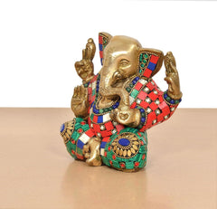 Brass Ganesha sculpture, gold-toned figure with multicolor patterned garment and arms up