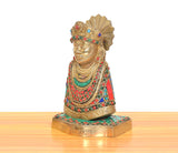 Khatu Shyam brass idol side view with jeweled collar, red robe, and decorative base