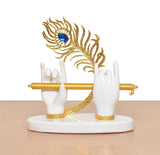 Front view: white resin Krishna hands with gold flute and blue peacock crown, round base