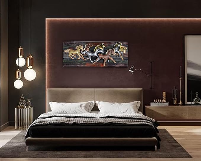 Framed metal wall art with seven running horses above bed in a dark bedroom