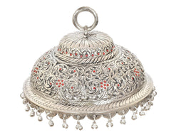 Carved silver chatta with circular loop handle; red jewel-like dots and fringe