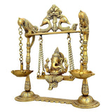 Close view of brass Ganesha swing idol with two lamp bowls and hanging chains