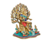 Dakshinamurti Shiva statue side view, golden figure with blue and red robes