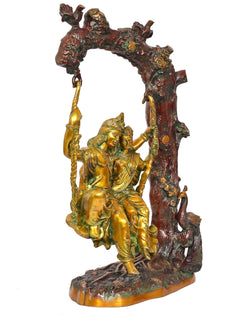 Brass Radha Krishna swing idol, close side angle with carved tree support and swing