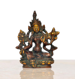 Seated Tara Devi idol in dark bronze with gold detailing, four-armed pose, 4-inch.