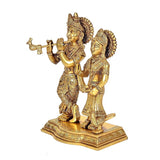 Brass Radha Krishna figurine, side angle showing flute and raised hand