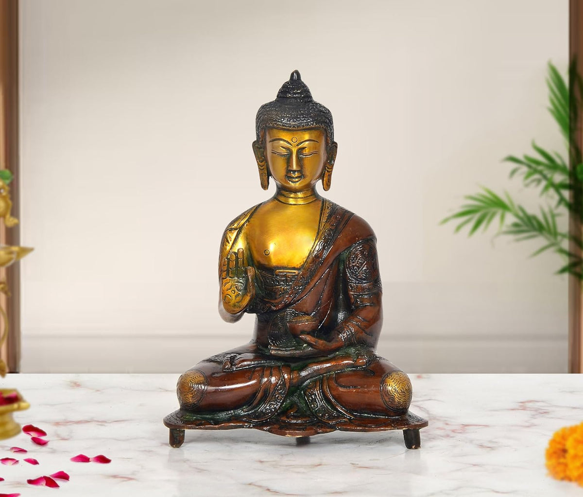 Brass Buddha statue seated in Abhaya mudra, gold face and dark robe, 9-inch