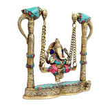 Brass Ganesha swing with parrot-shaped posts and beaded chains, colorful gem accents
