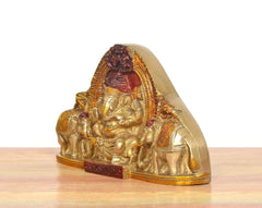 Brass Ganesha idol side view with elephants, red and gold painted accents