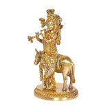 Brass khaniya statue: flute-playing figure holding a flute, cow beneath, 3/4 view