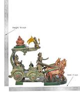 Brass chariot statue with Krishna and Arjuna figures and decorated wheels.