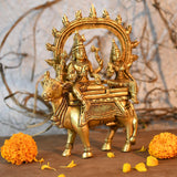 Brass Shiva Parvati idol on Nandi, side view with raised trident and jewelry