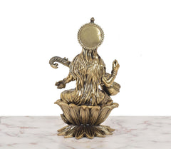 Brass Maa Saraswati idol rear view, seated on lotus, ornate circular halo