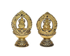 Brass diya oil lamp pair with Lakshmi and Ganesha figures in oval surrounds