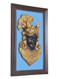Framed brass Thakurji face mask wall hanging, gold crown and jewelry on dark face