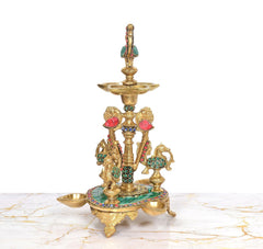 Brass peacock oil lamp stand with three peacock figures and round teal inlaid base
