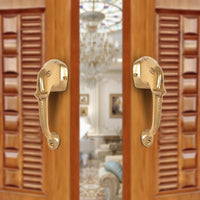 Brass Ganesha face door handle pair, curved lever with round mounting plates