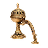 Brass incense stand with domed perforated lid and curved handle, upright on base