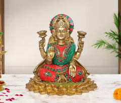 Brass Lakshmi idol seated on lotus base, raised arms, multicolor detailing