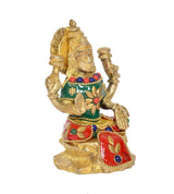 Brass Lakshmi idol statue, green top with flower motif and red skirt, angled view