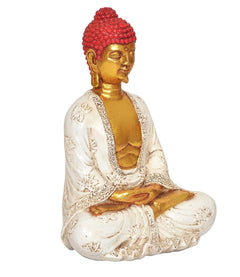 Buddha-Statue im Lotussitz, goldener Blick nach links, roter Kopf, weiße Robe