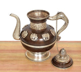 Himalayan brass teapot with wide open top, embossed motifs, and side handle with chain