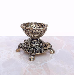 Brass tortoise diya oil lamp, side view with patterned chest and bowl