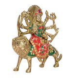 Durga Maa brass statue with lion mount, green/red ornaments, lion face visible