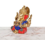Brass Ganpati idol side view with multicolor blue-red outfit, seated posture and arms
