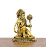 Golden Hanuman JI sitting brass statue, side view with detailed robes and mace
