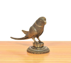 Brass parrot statue from rear angle, detailed scale-like feathers, lotus base