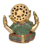 Back of Ganesha idol showing round face plate and jeweled torso with raised hands