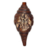 Decorative brass shankh with Radha-Krishna figures on body, carved ornate patterns