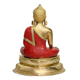 Brass Buddha statue, rear view, red robe with gold trim, seated on ornate pedestal