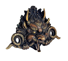 Brass cheepu mask wall decor, angled view of dragon face and horn shapes