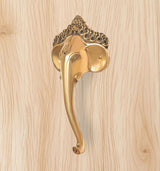Golden brass Ganesha face door handle with curved lever and arched crown ornament