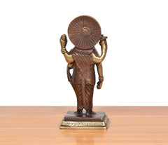 Brass Dhanvantri statue rear view with circular halo and flowing draped garment
