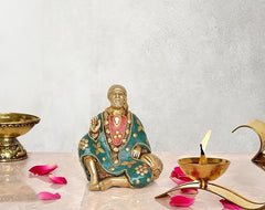 Seated Shirdi Sai Baba statue, brass with teal painted robe and bead details