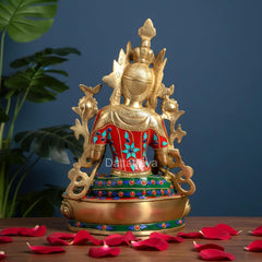 Back view of seated Tara Devi brass statue with ornate crown and multicolor robe