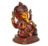 Ganesha idol statue angled view, golden face with red-brown body and ornate base
