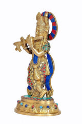 Brass Krishna figurine with raised flute, jeweled blue robe, circular base