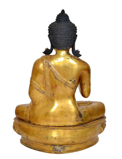 Rückansicht der Buddha-Statue aus Messing mit dunklem Kopfaufsatz und geschwungener Rückenform