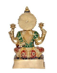 Brass Lakshmi idol back view, round halo and decorated green and red clothing