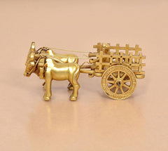 Brass bullock cart showpiece, close side view with spoked wheel and reins