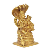 Gold brass Lakshmi Narasimha statue, angled view with spear-like staff and base