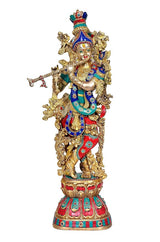 Brass Krishna murti standing, detailed gold crown, blue and red garments, flute raised